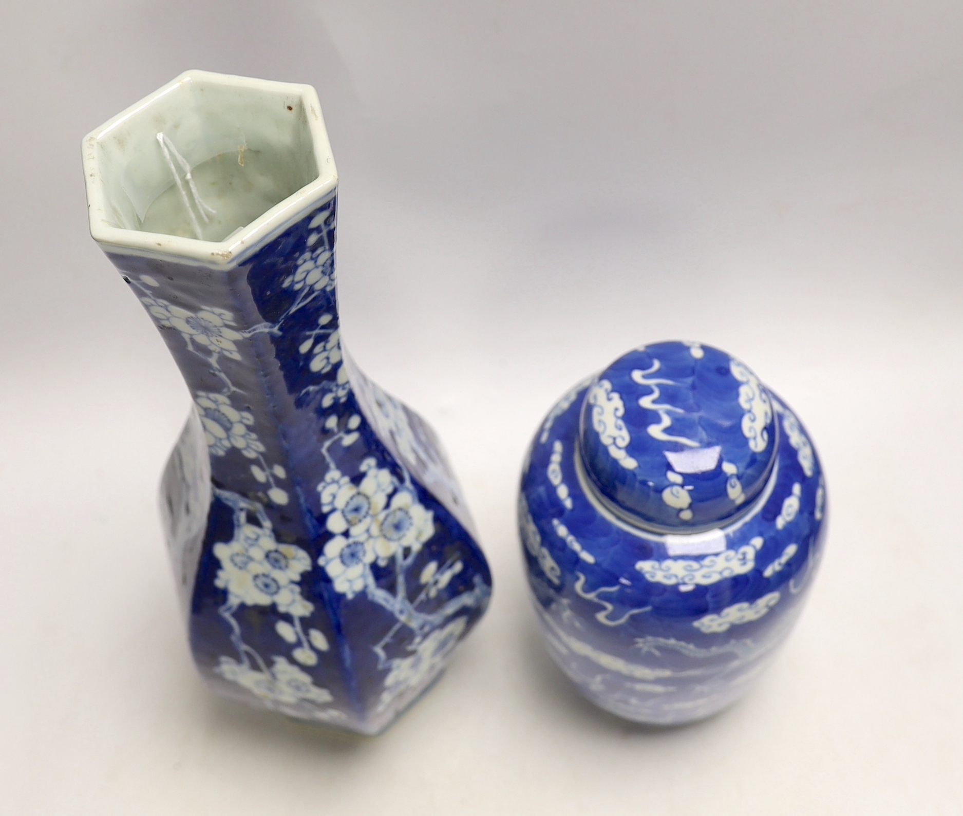 A Chinese blue and white hexagonal baluster vase, Qianlong mark, 19th century and a blue and white ‘dragon’ jar and cover, 19th century, tallest 36cm (2)